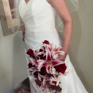 Wedding gown has been preserved in a box. Comes with veil, shoes clutch purse